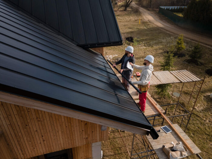 full-shot-roofers-working-with-helmets (1) PVC Roof Repair Berthoud CO